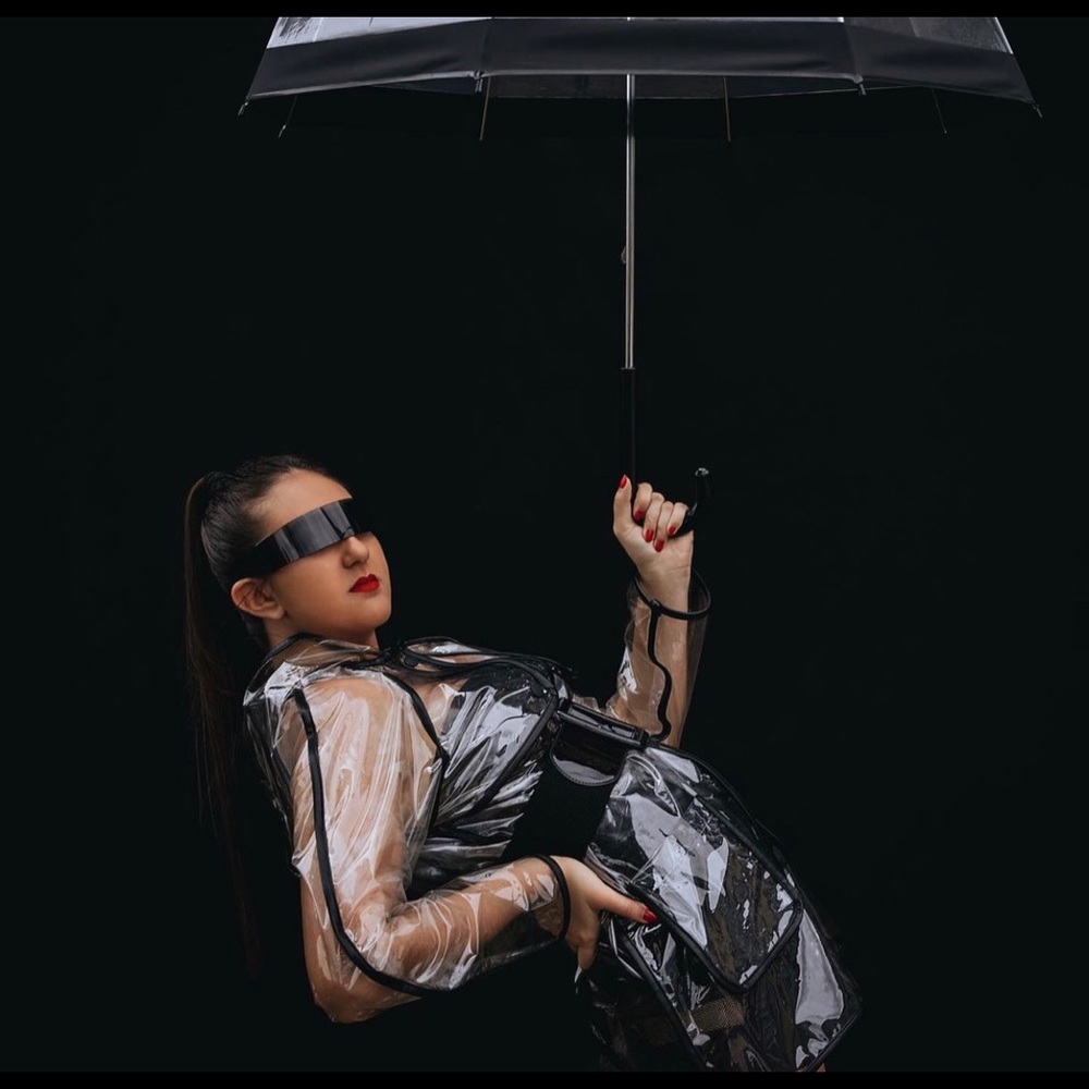 Clear raincoat with buttons and pockets.
